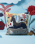 Decorative pillow with animal design on a blue background with flowers and leaves.
